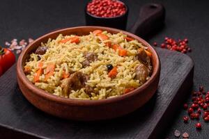 Delicious pilaf with vegetables, salt, spices and herbs in a ceramic plate photo