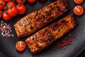 Delicious red salmon fish grilled with sauce and sesame, spices and herbs photo