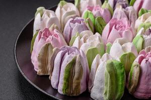 Beautiful tasty marshmallows in the form of tulip buds photo