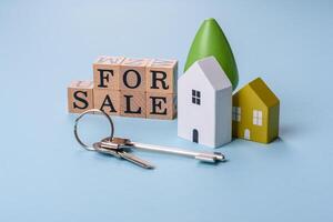 A small wooden house and keys as an idea for investing in your own home photo