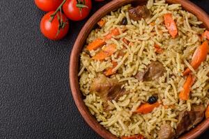 Delicious pilaf with vegetables, salt, spices and herbs in a ceramic plate photo