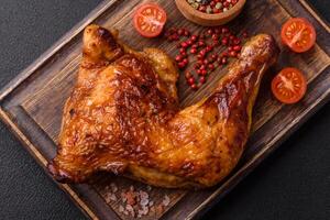 Delicious grilled chicken leg or quarter with salt and spices photo