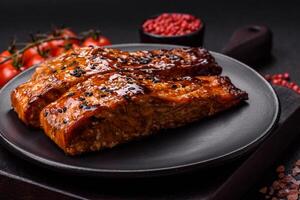 Delicious red salmon fish grilled with sauce and sesame, spices and herbs photo