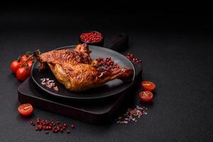 Delicious grilled chicken leg or quarter with salt and spices photo