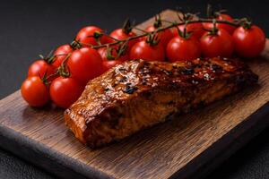 Delicious red salmon fish grilled with sauce and sesame, spices and herbs photo