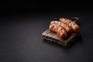 Grilled sausages with spices and herbs. With copy space photo
