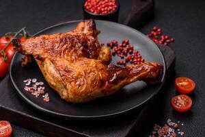 Delicious grilled chicken leg or quarter with salt and spices photo