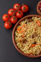 Delicious pilaf with vegetables, salt, spices and herbs in a ceramic plate photo