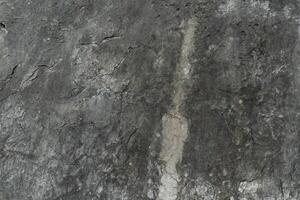 Stone floor has a unique rough surface and dark color. For background and textured. photo