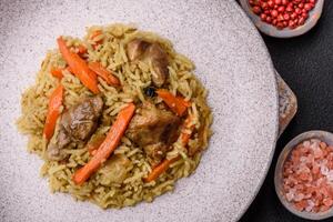 Delicious pilaf with vegetables, salt, spices and herbs in a ceramic plate photo