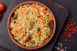 Delicious pilaf with vegetables, salt, spices and herbs in a ceramic plate photo