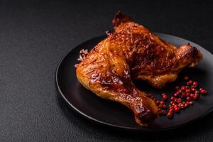 Delicious grilled chicken leg or quarter with salt and spices photo