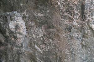 Stone floor has a unique rough surface and dark color. For background and textured. photo