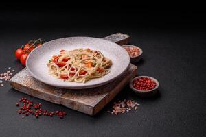 Delicious rice noodles or udon with chicken, carrots, pepper, salt, spices and herbs photo