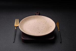 Cutlery fork, knife and spoon on a dark textured concrete background photo