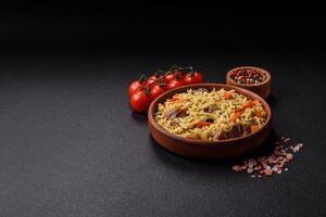 Delicious pilaf with vegetables, salt, spices and herbs in a ceramic plate photo