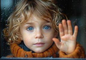 AI generated Child behind a window with his hand on the glass looking thoughtful photo