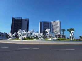 MAKASSAR, INDONESIA - FEBRUARY 7th, 2023 - group of white horses in front of a building at Center point of Indonesia Makassar photo