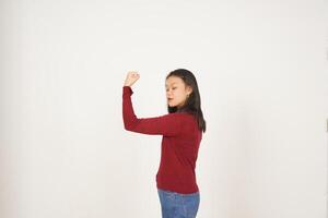 Young Asian woman in Red t-shirt Showing strong arms, emancipation of women concept isolated on white background photo