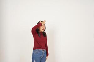 Young Asian woman in Red t-shirt hand on head, Forget something gesture isolated on white background photo