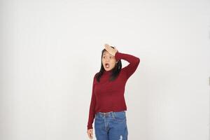 Young Asian woman in Red t-shirt hand on head, Forget something gesture isolated on white background photo