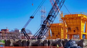 A timelapse of moving cranes at the under construction telephoto shot zoom video