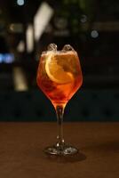Aperol Spritz glass on dark restaurant background photo