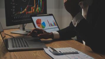 Businessman analyzing a graphic of a stock exchange chart. Back of the head of a young male businessman looking at a stock diagram on the big screen of the computer video