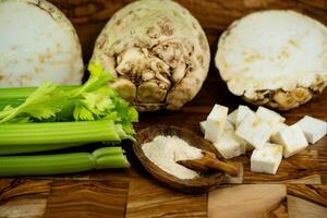 Fresh celery Apium graveolens on olive wood photo