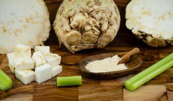 Fresh celery Apium graveolens on olive wood photo