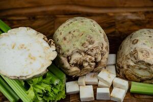 Fresh celery Apium graveolens on olive wood photo