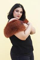 a woman wearing a black top and a brown fur stole photo