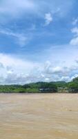 view of serayu river with big current, river landscape at day photo