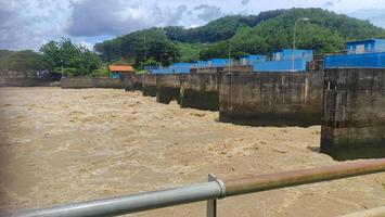 view of serayu river with big current, river landscape at day photo