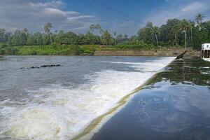 A beautiful view of a waterfall from a check dam In Kerala, India. photo