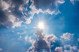 blue sky with clouds and sun shines photo