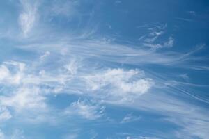 Beautiful wispy cirrus clouds in blue sky on freedom, energize and joyful sunny day photo