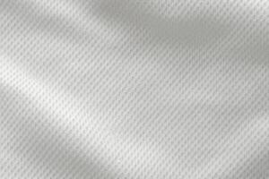 A close-up top view of the texture of a white sports fabric jersey football shirt. photo