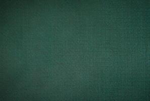 abstract festive background of dark fabric and green photo