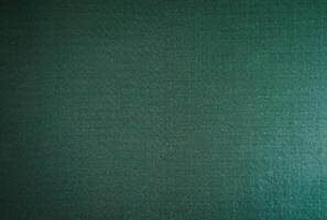 abstract festive background of dark fabric and green photo