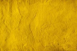 Background texture of yellow concrete wall photo