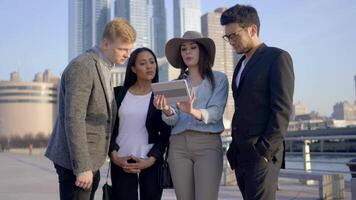 Group of Diverse Multi Ethnic Mixed Race People Watching Video On Tablet