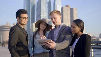 Group of Diverse Multi Ethnic Mixed Race People Watching Video On Tablet