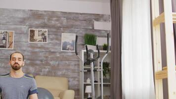 Man practicing mindfulness on yoga mat in cozy living room. video