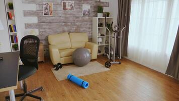 Ball for fitness training and yoga mat in empty room. video