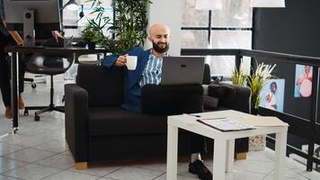 Executive assistant researching data on laptop while he works in small business workspace. Startup employee planning project and presentation, solving agency tasks for development. photo