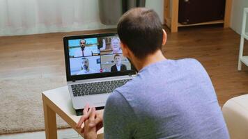 Man talking business strategy on video call during a webinar in time of global pandemic.