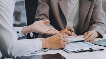 Business team meeting present, investor colleagues consultation and conference new strategy plan business and market growth on financial document graph report, Meeting and Talking. video