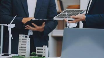 Diverse group of business people planning for alternative energy utilization for greener sustainable Earth by reducing CO2 emission and carbon credit with renewable clean energy technology. Quaint video