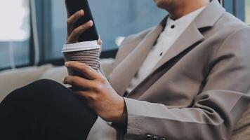 Smiling businesswoman using phone in office. Small business entrepreneur looking at her mobile phone and smiling. video